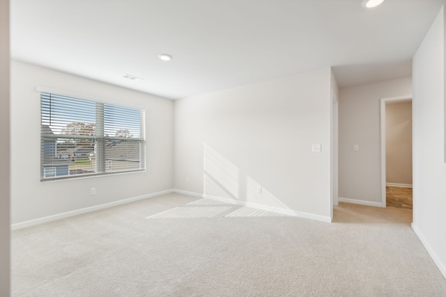 unfurnished room with light carpet