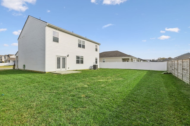 back of property featuring a patio area and a lawn