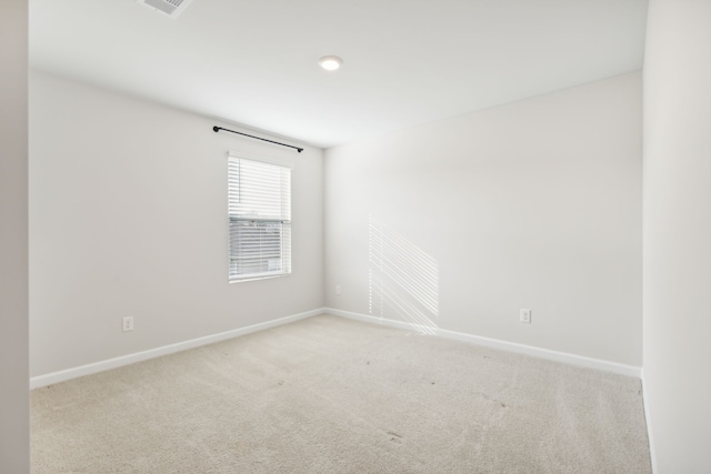 unfurnished room with light colored carpet