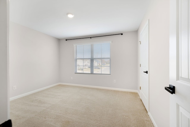 unfurnished room featuring light carpet