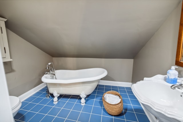 bathroom featuring toilet, sink, vaulted ceiling, and a washtub