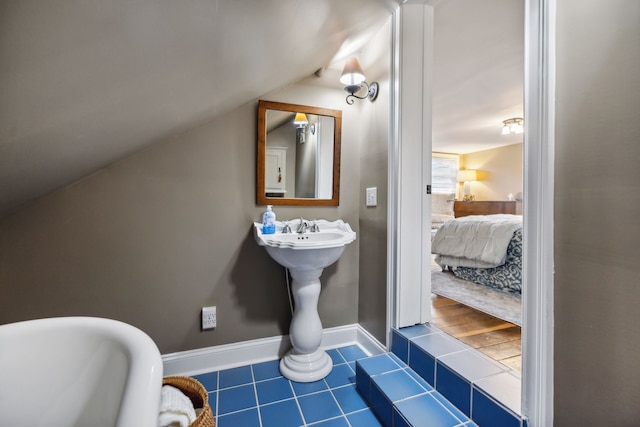 bathroom featuring tile patterned floors and vaulted ceiling