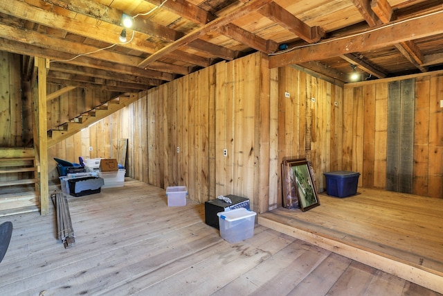 basement with hardwood / wood-style flooring, wood walls, and wood ceiling