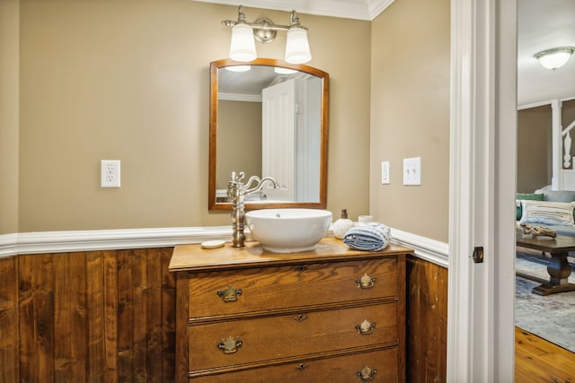 bathroom with hardwood / wood-style floors, vanity, and crown molding