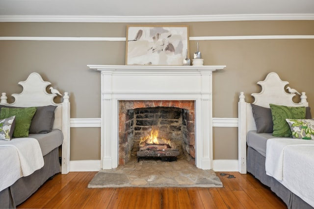 bedroom with hardwood / wood-style floors and crown molding