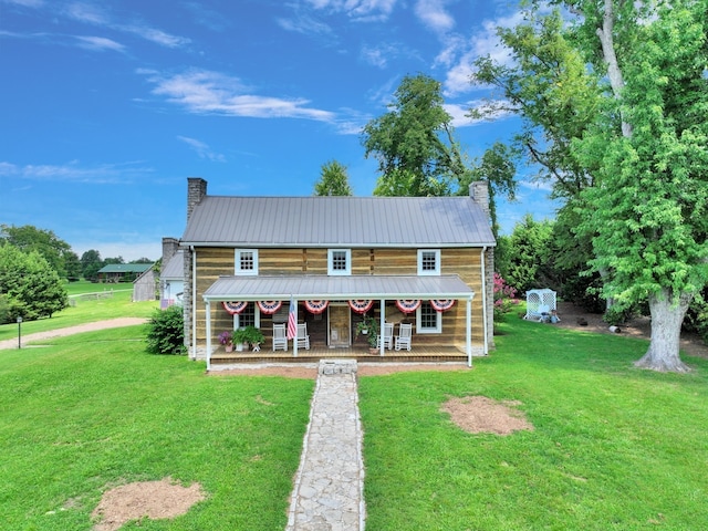 view of front of house featuring covered porch and a front yard