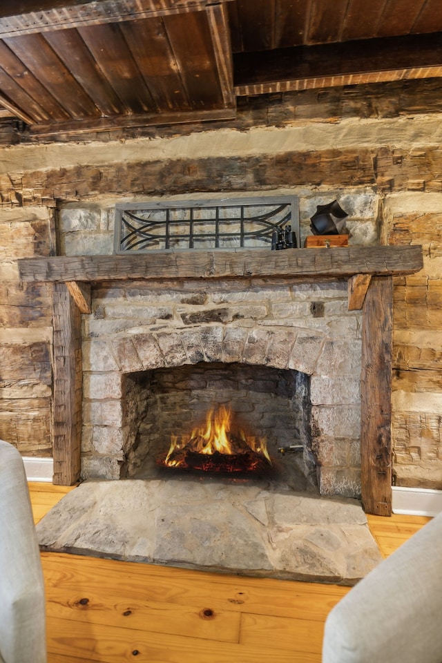 room details featuring a fireplace, hardwood / wood-style floors, and wooden ceiling