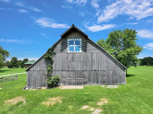 view of side of home with an outdoor structure and a lawn