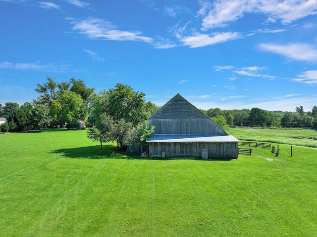 view of yard with a rural view and an outdoor structure