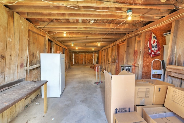 basement with white refrigerator