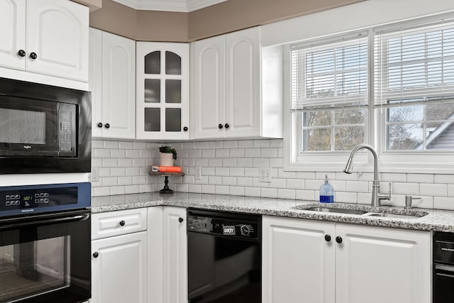 kitchen featuring sink, white cabinets, black appliances, and ornamental molding