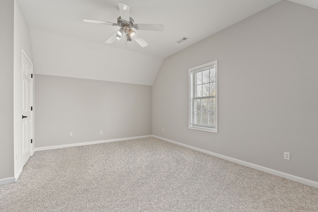 additional living space featuring ceiling fan, carpet floors, and vaulted ceiling