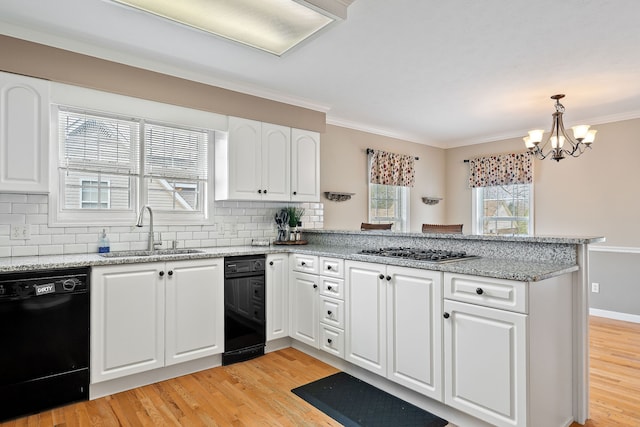 kitchen featuring stainless steel gas cooktop, crown molding, sink, dishwasher, and white cabinetry