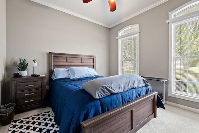 carpeted bedroom featuring ceiling fan, crown molding, and multiple windows