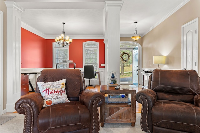 living room with a chandelier, crown molding, light carpet, and decorative columns