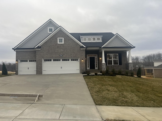 craftsman-style home with a porch, a garage, and a front lawn