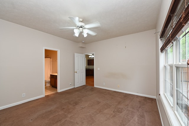 carpeted empty room with a textured ceiling and ceiling fan