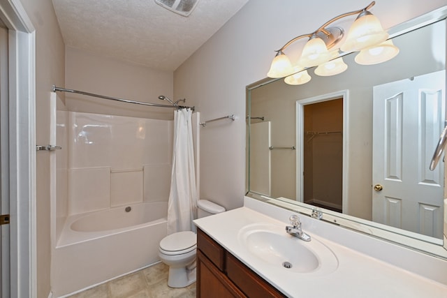 full bathroom featuring tile patterned floors, vanity, a textured ceiling, shower / tub combo with curtain, and toilet