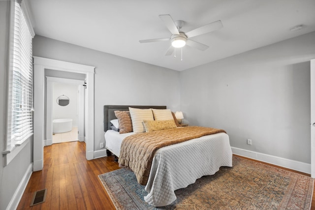 bedroom with ensuite bath, ceiling fan, and dark wood-type flooring