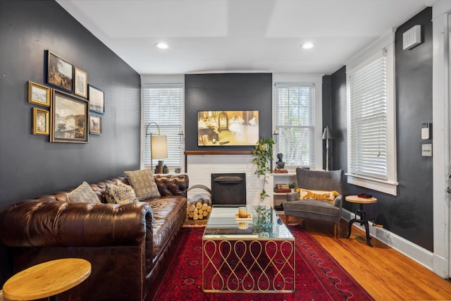 living room featuring hardwood / wood-style flooring and a fireplace