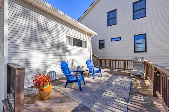 wooden terrace featuring a grill