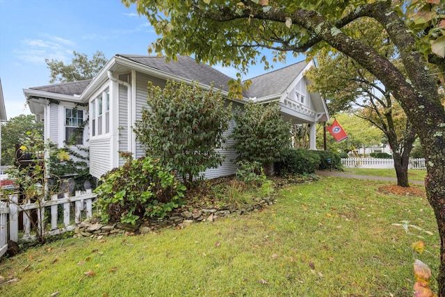 view of side of property featuring a yard