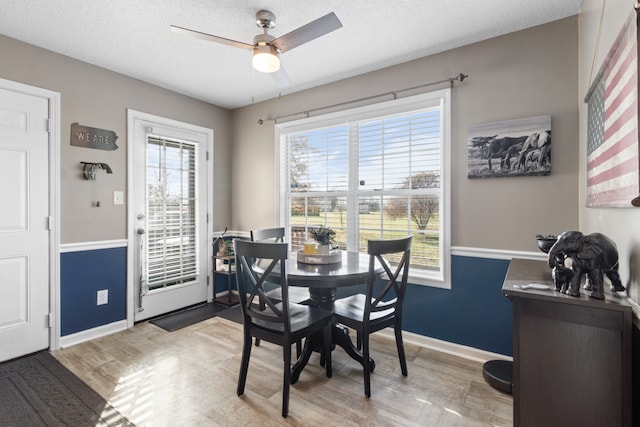 dining room featuring ceiling fan and a textured ceiling