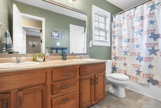 full bathroom with shower / tub combo with curtain, vanity, toilet, and tile patterned floors