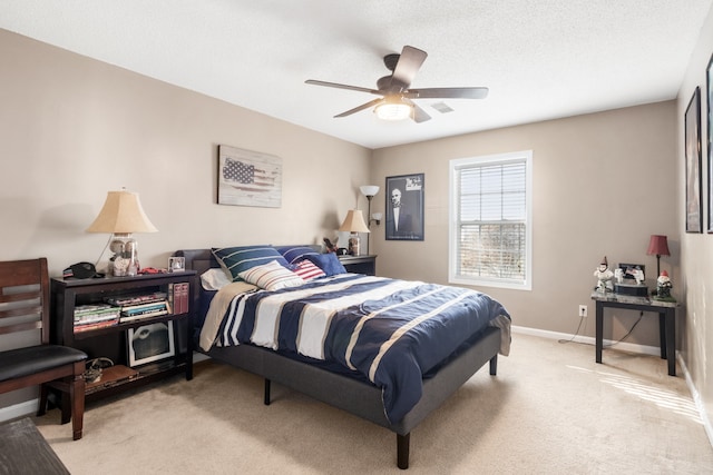 carpeted bedroom featuring a textured ceiling and ceiling fan