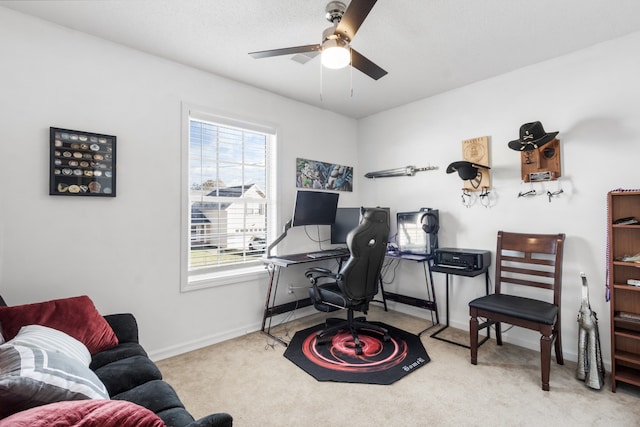 carpeted office featuring ceiling fan