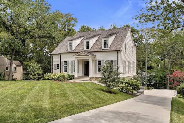 cape cod-style house featuring a front lawn