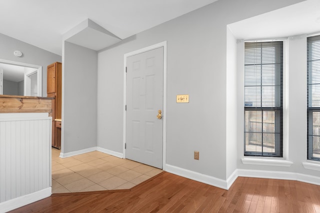 foyer entrance with lofted ceiling and light wood-type flooring