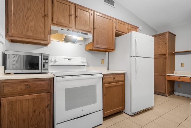 kitchen featuring lofted ceiling, white appliances, and light tile patterned floors