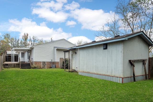 rear view of property featuring a lawn