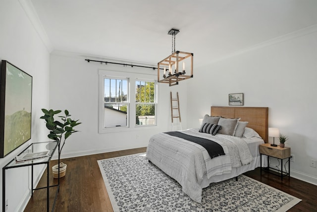 bedroom with crown molding, dark wood-type flooring, and an inviting chandelier