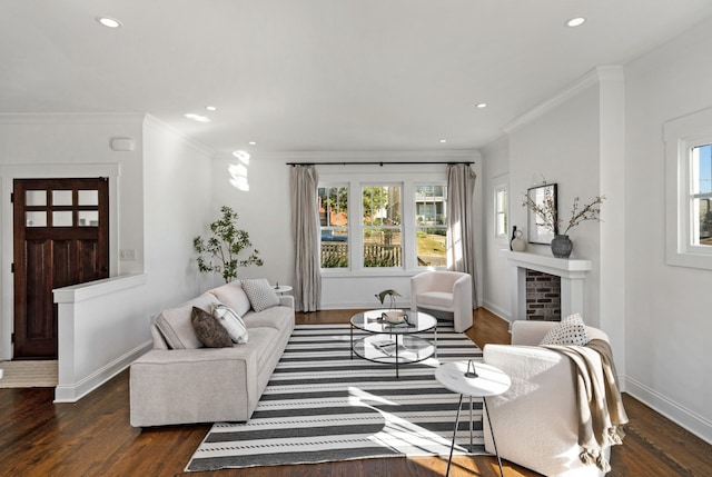 living room featuring crown molding, dark hardwood / wood-style floors, and a brick fireplace