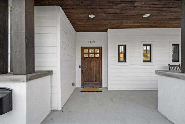 view of exterior entry featuring a porch