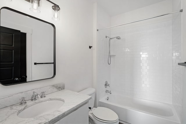 full bathroom featuring vanity, tiled shower / bath combo, and toilet