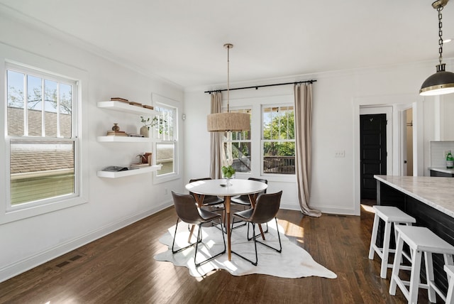 dining area featuring dark hardwood / wood-style floors and a healthy amount of sunlight