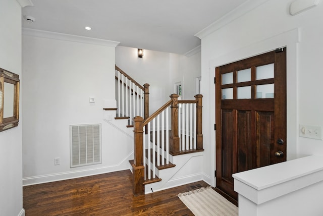 foyer with dark hardwood / wood-style flooring and ornamental molding