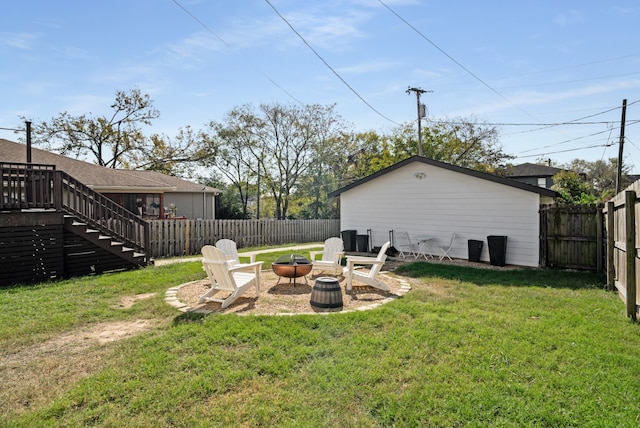 view of yard with an outdoor fire pit and a wooden deck