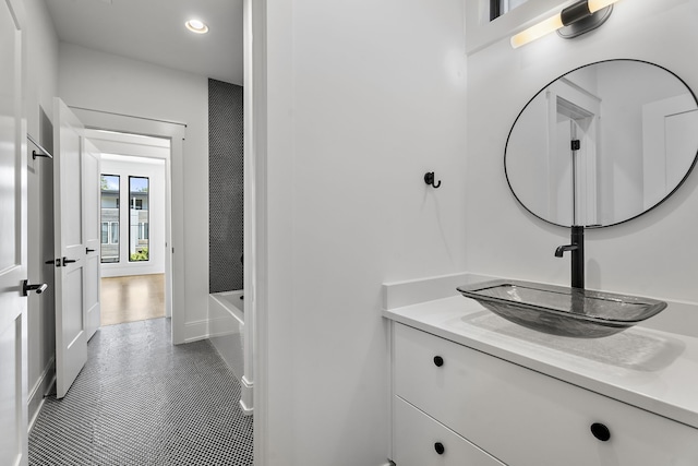 bathroom featuring vanity, tile patterned floors, and a bathing tub