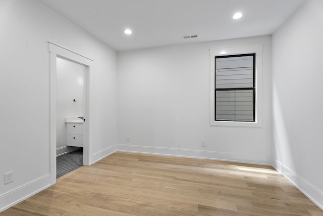 spare room featuring light hardwood / wood-style floors