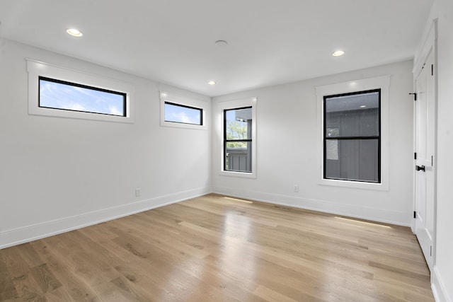 unfurnished room with light wood-type flooring