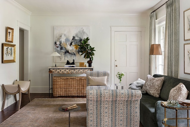 sitting room with dark hardwood / wood-style floors and ornamental molding