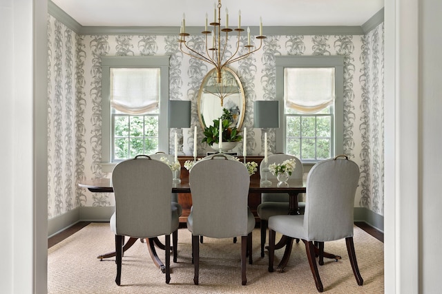 dining space featuring plenty of natural light, ornamental molding, light carpet, and an inviting chandelier