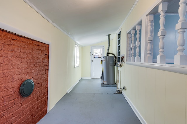 hallway with crown molding, water heater, concrete floors, and lofted ceiling