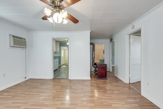 empty room with a wall mounted air conditioner, light hardwood / wood-style flooring, and ornamental molding