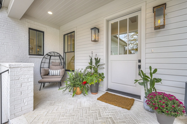 view of exterior entry with a porch