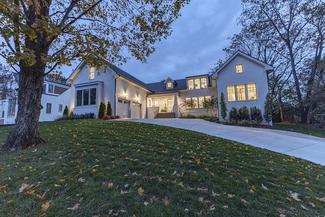 view of front of home featuring a lawn and a garage